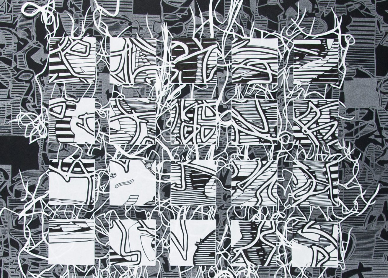 A black and white picture of many different types of graffiti.