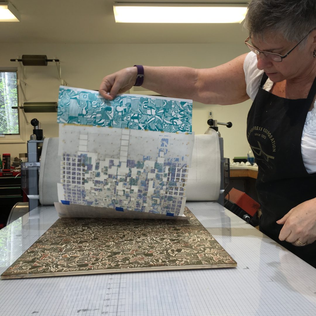 A woman is working on some fabric