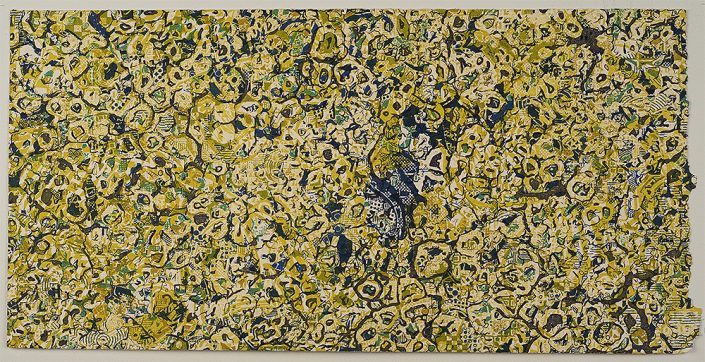 A close up of the surface of a yellow and green painting